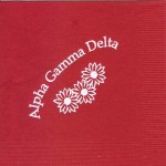 Alpha Gamma Delta red napkin white foil daisies